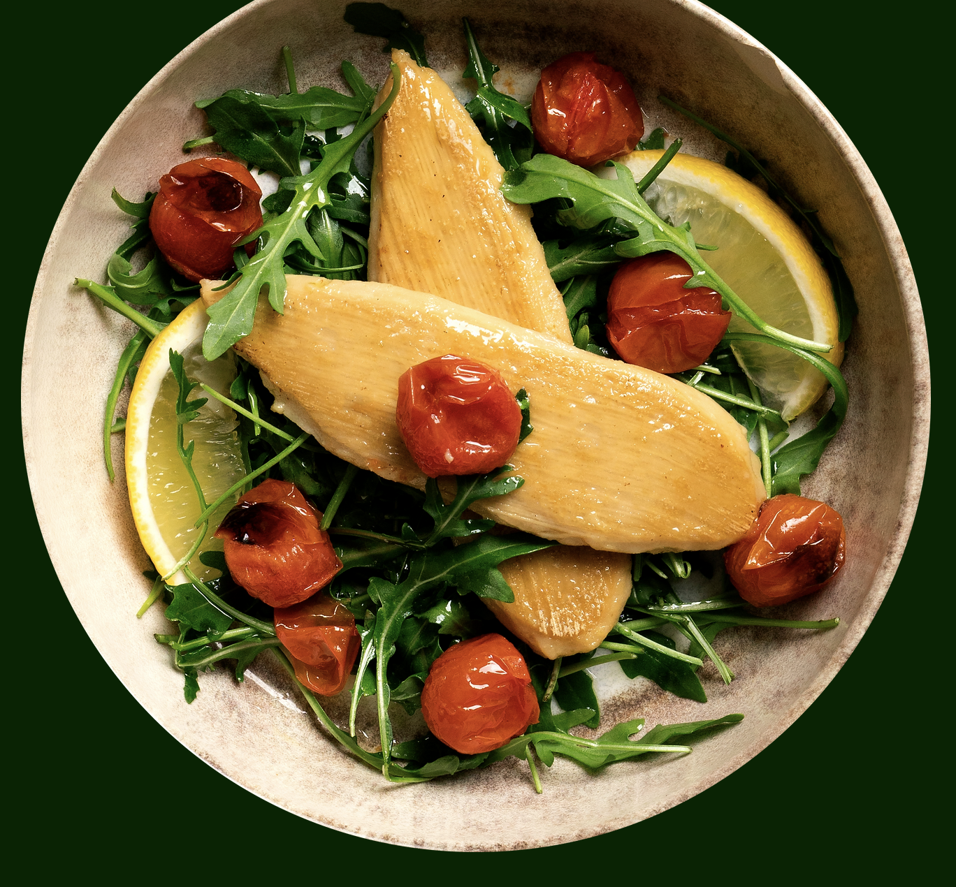 Plate of Novameat with arugula, tomato, and lemon